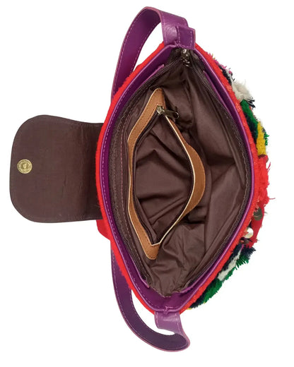 Colorful handbag with a textured surface and visible brand logo on a white background