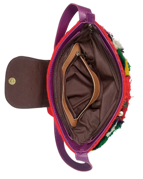 Colorful handbag with a textured surface and visible brand logo on a white background