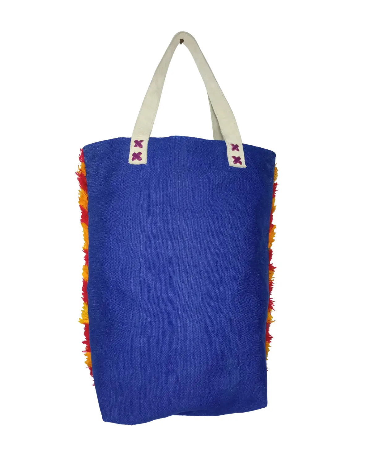 Detailed view of the off-white handles of a tribal boho tote, showing the 'X' stitching where they attach to the blue bag.