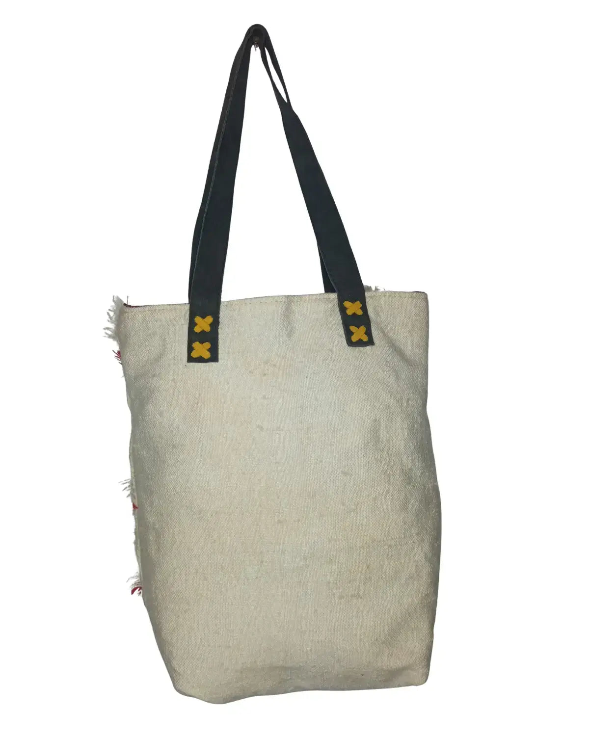 Beige tote bag with black straps on a white background