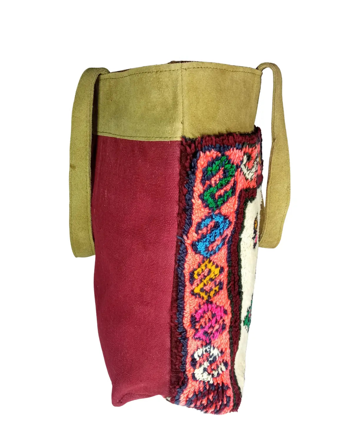 Close-up of the plush, shaggy wool texture of a Moroccan rug bag, showcasing the vibrant green, pink, and yellow tribal pattern.