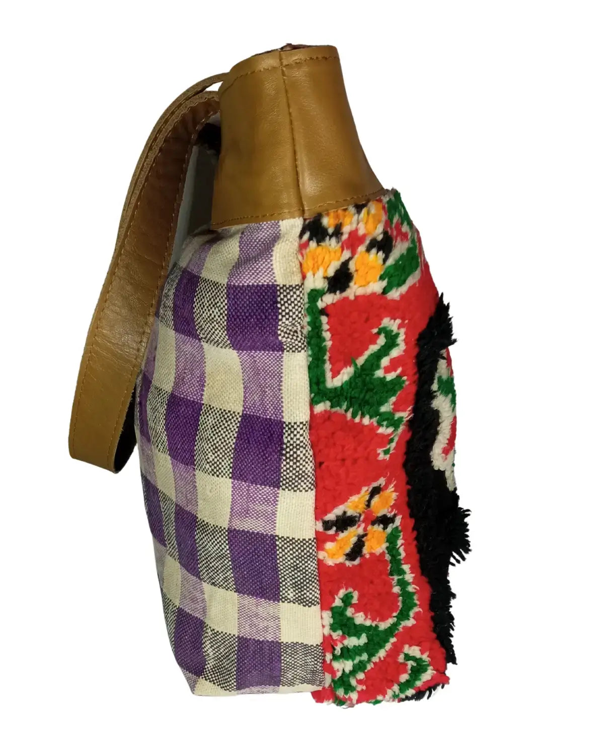 Colorful patchwork bag with a brown leather strap on a white background