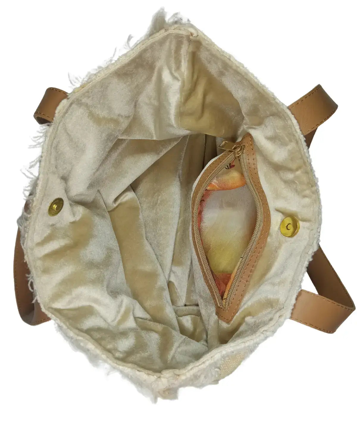 Beige textured bag with brown leather straps on a white background