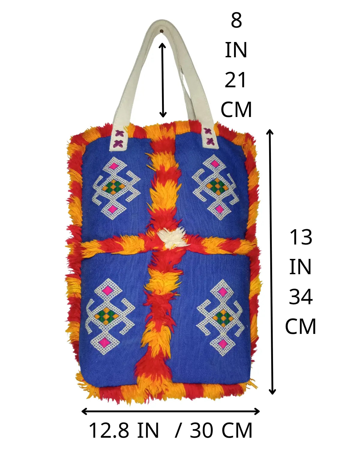 Detailed view of the off-white handles of a tribal boho tote, showing the 'X' stitching where they attach to the blue bag.