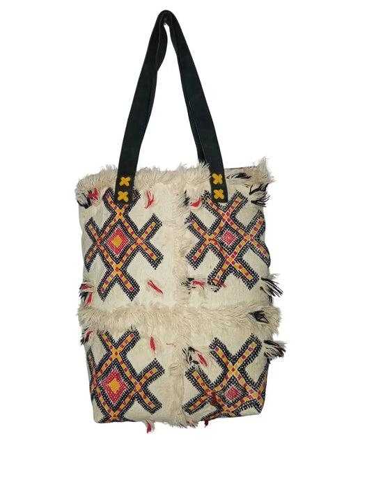 Tote bag with geometric pattern and fringes on a white background
