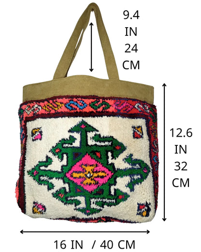 Detailed view of the tan suede shoulder straps and top panel of a handmade boho tote bag, showing the texture and stitching.