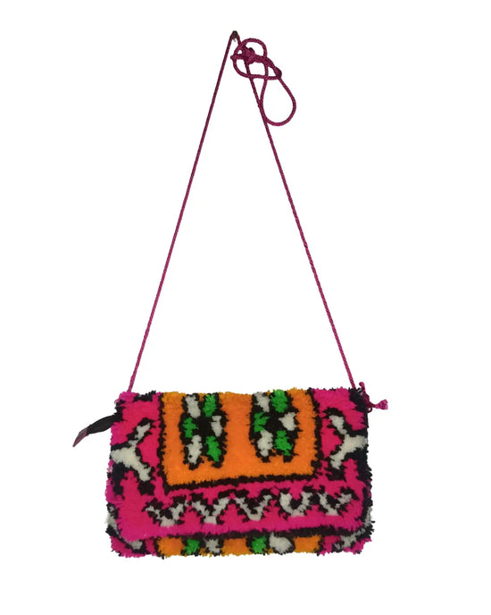 Colorful patterned handbag with a pink strap on a white background