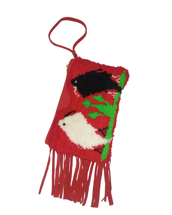 Red fringed pouch with black and white designs on a white background