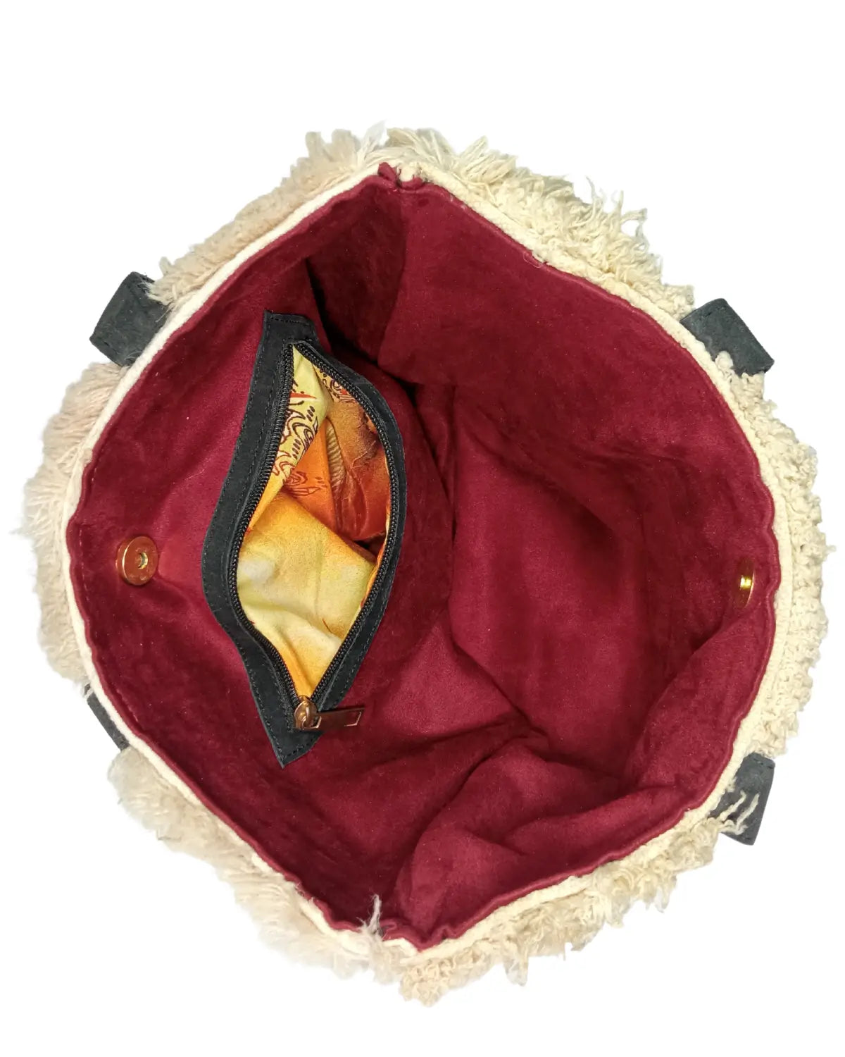 Top section of a bohemian wool tote bag, highlighting the attachment point of the black leather strap, which is reinforced with red stitching.