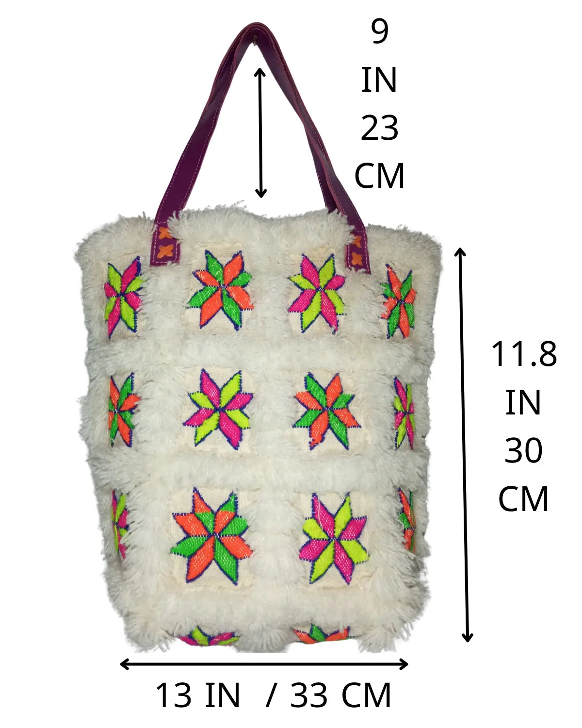 Detailed view of the vibrant neon embroidery on the white faux fur material of a retro tote bag, showing the star-shaped patterns in fuchsia, lime green, and orange

