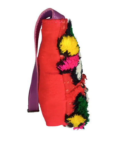 Red bag with colorful pom-pom details on a white background