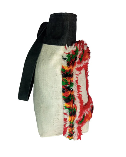 Bag with a colorful, patterned strap on a white background